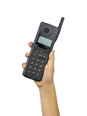 Vintage vintage phone with external antenna in child's hand isolated on white background. Retro means of communication.