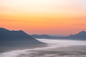 Fototapeta na wymiar Mountain range with visible silhouettes through the morning fog at Phu Tok Mountain in Chiang Khan district, Loei province.