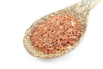 red rice in wooden spoon