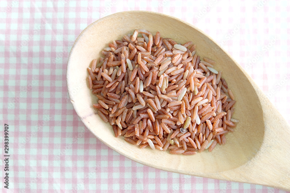 Wall mural red rice in wooden spoon