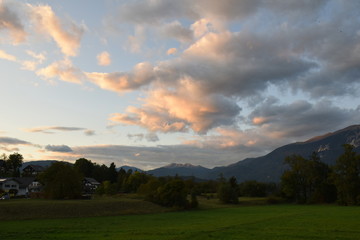 Fototapeta na wymiar Last light, sun setting on clouds and mountain, landscape, Bled, Slovenia