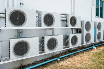 Group of air compressors outside the industry building wall. Air compressors installed in the factory. 