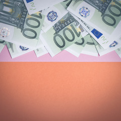 Euro cash on a pink and orange background. Euro Money Banknotes. Euro Money. Euro bill. Place for text.