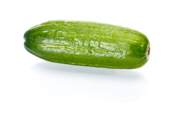 Small green cucumber with a light shadow