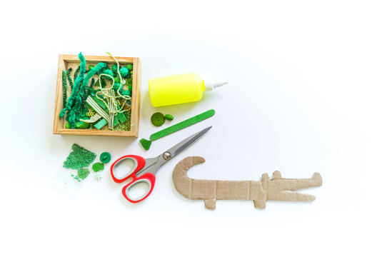 Craft cardboard crocodile. Decoration beads and buttons.