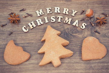 Gingerbreads, inscription Merry Christmas and ingredients for baking. Vintage photo