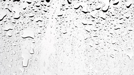 Water rain droplets on clear transparent glass background, clear water vapor bubbles on window glass surface.