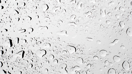 Water rain droplets on clear transparent glass background, clear water vapor bubbles on window glass surface.