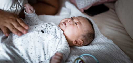 Cute asian baby lying on bed