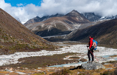 Fototapeta premium Active hiker hiking, enjoying the view, looking at Himalaya mountains landscape. Travel sport lifestyle concept