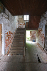 Stairway in old abandoned brick house