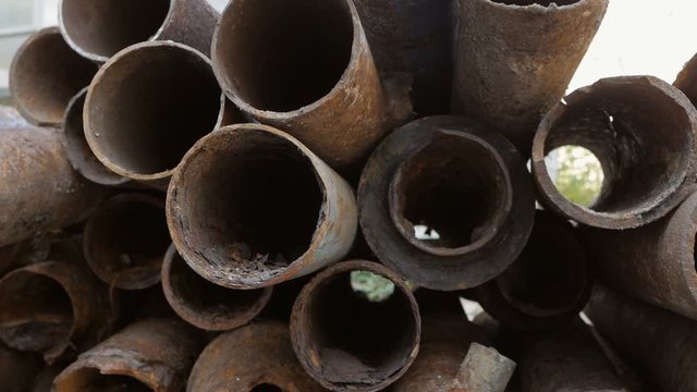Fragments of rusty metal pipes are stacked