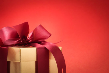 Valentine festival , New year Gold gift box with red ribbon. Red background for create idea copy space.