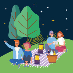 two couples with mobile and tablet blanket lanterns picnic night