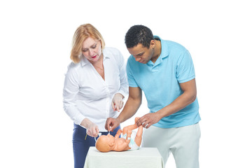 A young black man is being trained by an obstetrician to care for an unborn child. Learning on the layout of the child.