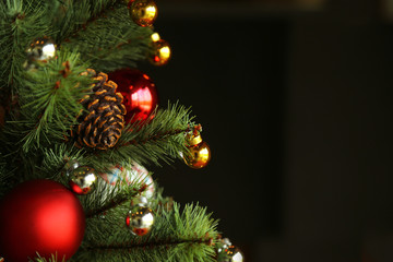 Decorated Christmas tree with black background and copy space.