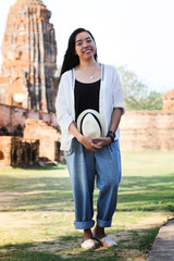 Asian tourist exploring the famous ruins of Ayutthaya Historical Park in Thailand