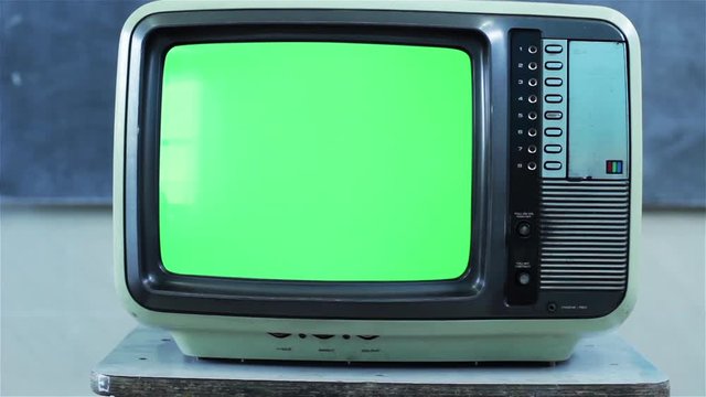 Retro Television Set with Green Screen Exploding in a Classroom. Dolly In. You can replace green screen with the footage or picture you want. You can do it with “Keying” effect in After Effects.