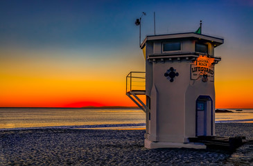 Sunset in Laguna Beach, famous tourist destination in California, USA with a lifeguard station in the foreground