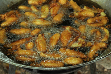 Bananas frying in pan with hot oil. Thai Snack.