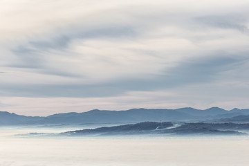 A view of Umbria valley with layers of hills and mountains and mist