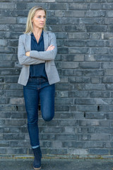 Middle-aged fit woman wearing cool slim blue jeans