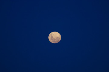 Full moon against blue night sky