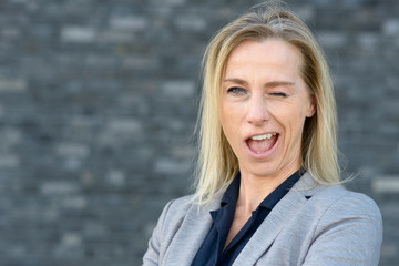 Blond woman winking in funny way