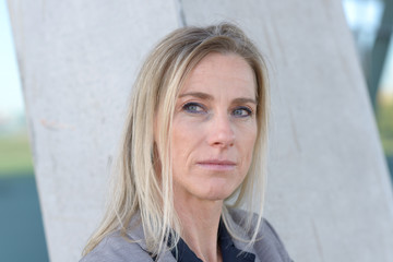 Middle-aged blond woman deep in thought