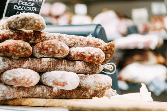  Food and meat in Italy. Smoked sausage in the shop window.