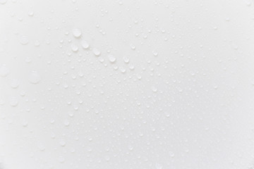 Raindrops on a grayish white background. Rainy season concept.
