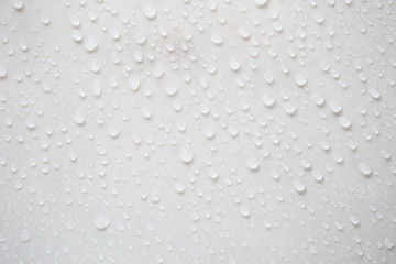 Raindrops on a grayish white background. Rainy season concept.