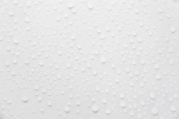 Raindrops on a grayish white background. Rainy season concept.