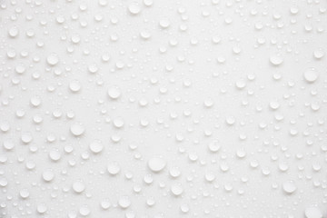 Raindrops on a grayish white background. Rainy season concept.