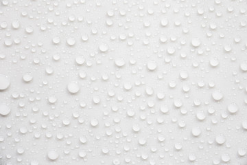 Raindrops on a grayish white background. Rainy season concept.