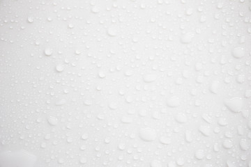 Raindrops on a grayish white background. Rainy season concept.