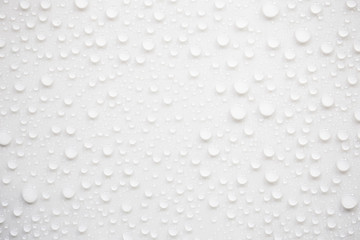 Raindrops on a grayish white background. Rainy season concept.
