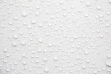 Raindrops on a grayish white background. Rainy season concept.