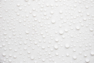 Raindrops on a grayish white background. Rainy season concept.