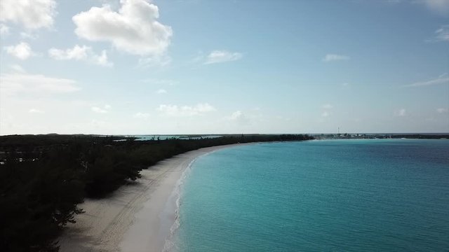 High Drone Flight footage over Island sandy beach with crystal clear water Bahamas Half Moon Cay