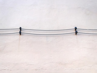 Two Rows of Electrical Power Cables on White Wall