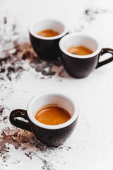 Three cups of freshly brewed espresso coffee