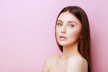 Beauty model with natural make up on pink background
