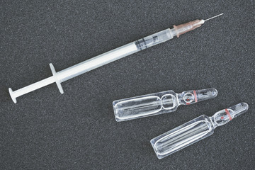 Syringes and vials of medicine on pavement. Hospital treatment. Medicine with liquid injections