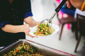 Compassion in human society leads to free food donations to the poor: poor people still need food, concept of feeding to the poor