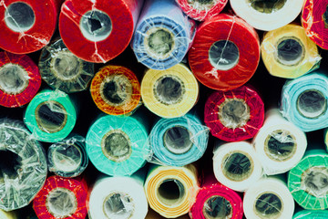 Rolls of colored wrapping paper on counter of store. Holiday and scrapbooking goods