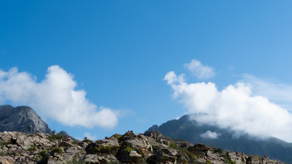 Rocks under blue sky with clouds. Mountain Hiking, summer tourism