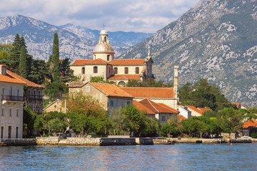 Fototapeta na wymiar Montenegro. View of Prcanj town and Birth of Our Lady Church. Kotor Bay of Adriatic Sea