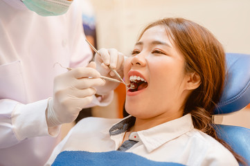 Dentist examining  teeth patients in clinic for better dental health and a bright smile.