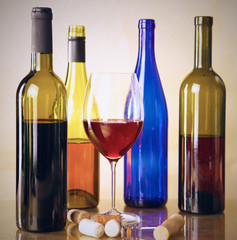 wine bottle and wine glass on a glass table